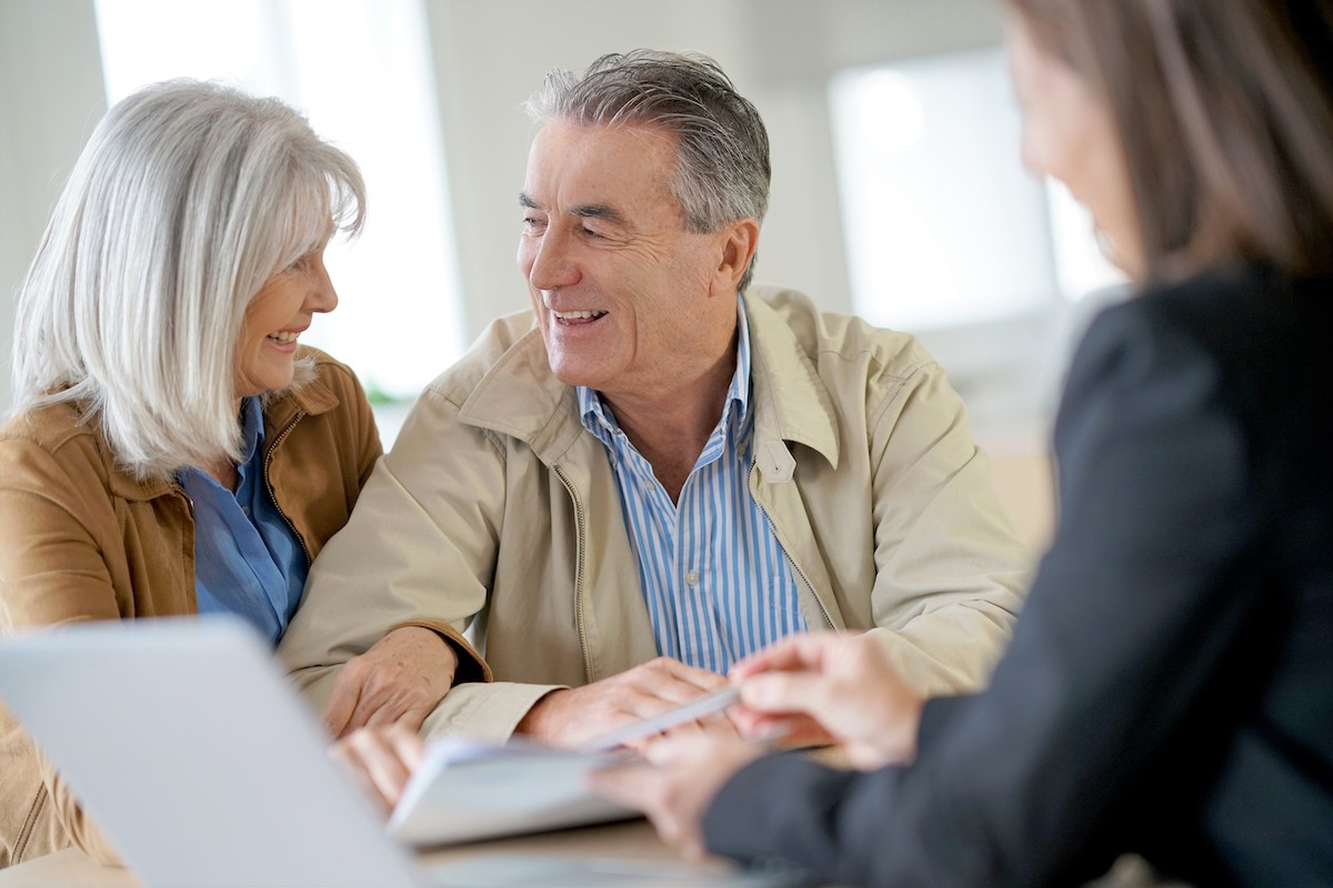 Senior couple meeting financial adviser for investment